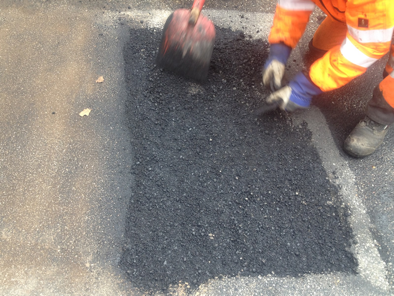 Den beschädigten Asphalt nach der Erwärmung ausbauen.